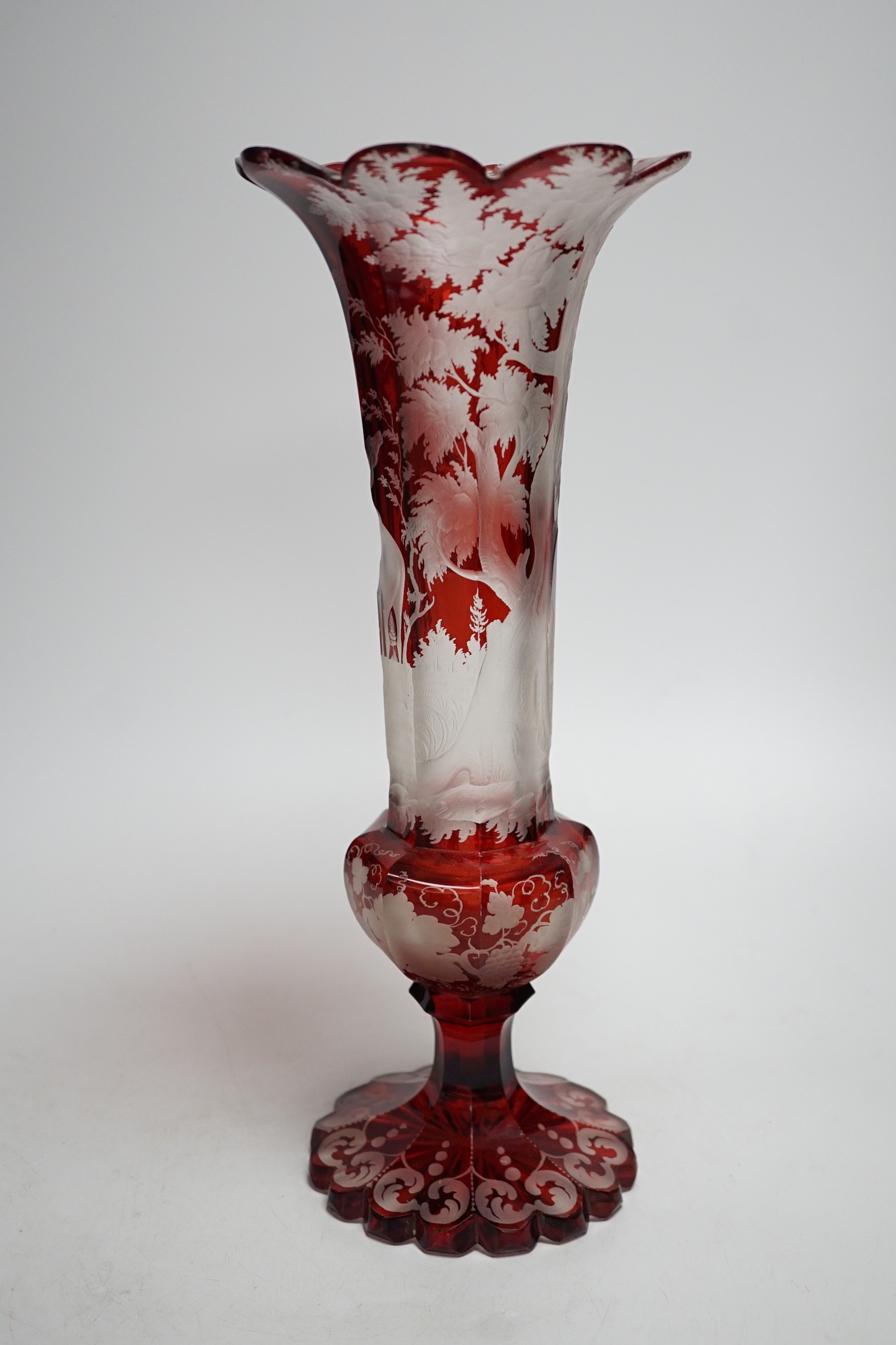 A Bohemian wheel engraved ruby glass vase (a.f.). 35cm tall